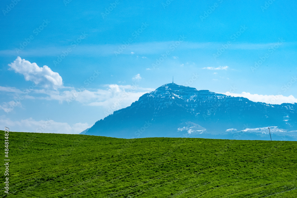 Fototapeta premium View from a green field towards mount Rigi, a famous mountain in Switzerland, Europe