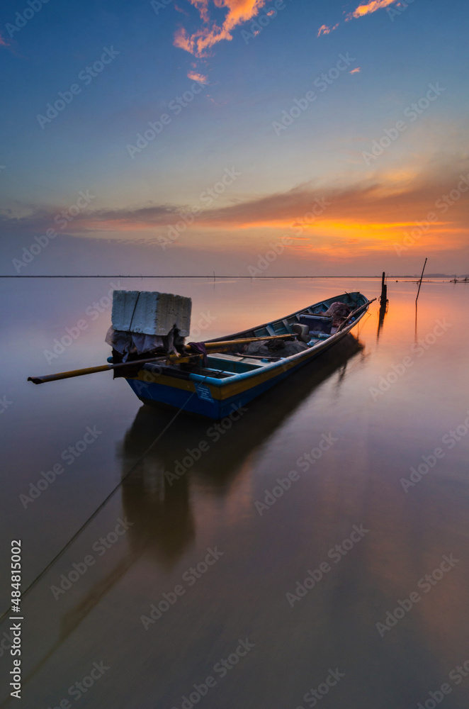Beautiful scenery of a sunrise with a view of a boat