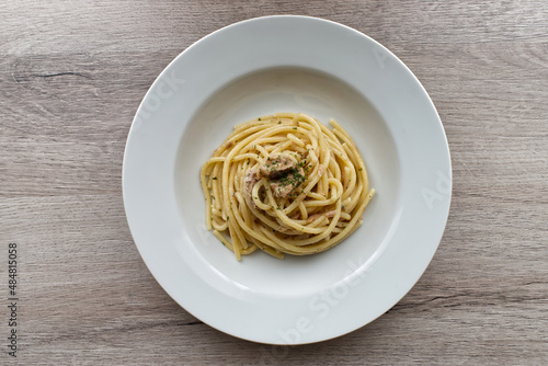 Italian Spaghetti Pasta with Tuna (Spaghetti al tonno) on wooden background. Top view.