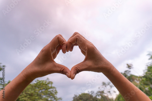 Woman making heart with her hands.