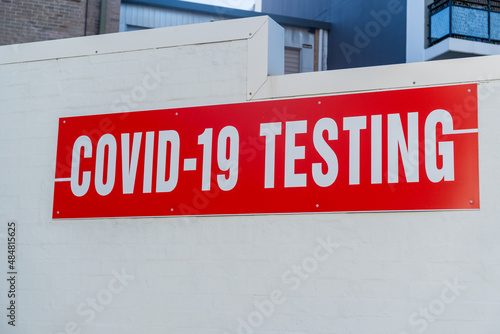 COVID-19 testing clinic sign on a wall. Coronavirus PCR test