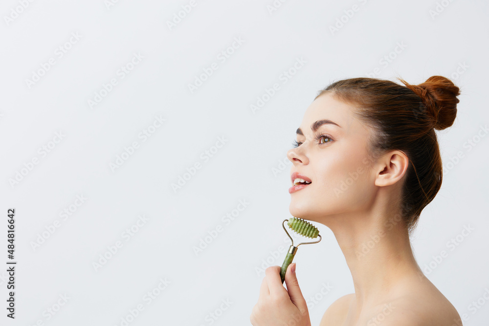 pretty woman jade face massager wrinkle smoothing light background pretty woman jade face massager wrinkle smoothing light background