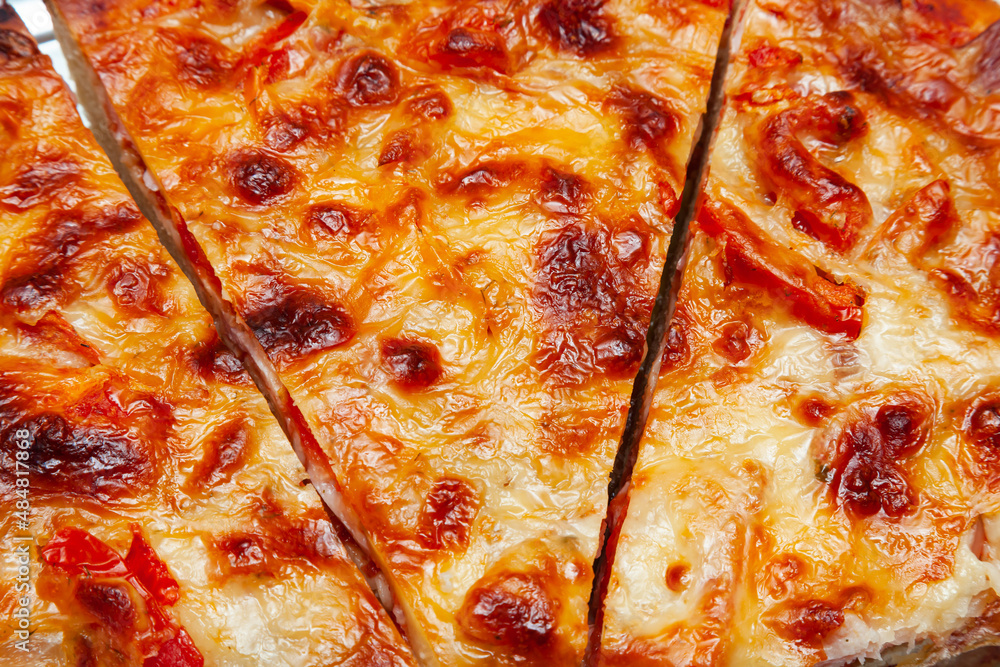 Sliced pizza slices with a lot of cheese, close-up. Sliced pizza slices with a lot of cheese, close-up.