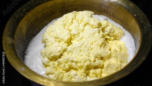 Butter melting in a old brass pot closeup