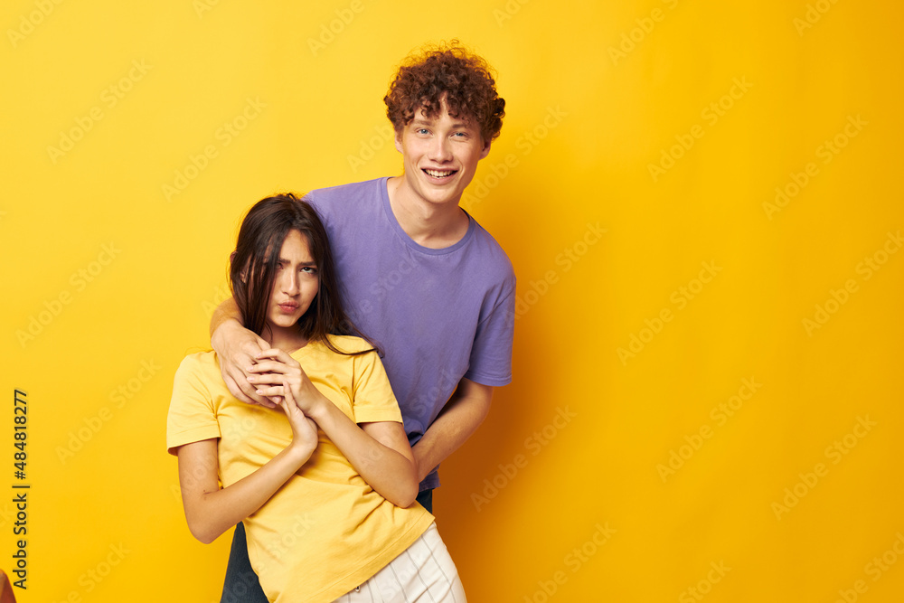 portrait of a man and a woman casual clothes posing emotions antics yellow background unaltered portrait of a man and a woman casual clothes posing emotions antics yellow background unaltered
