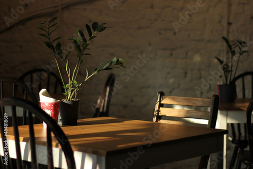 wooden chair and table in sunlight. Details of modern design.