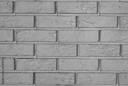 The texture is a dark brick wall. dark beautiful bricklaying. brickwork. abstract background. horizontal part of grey wall