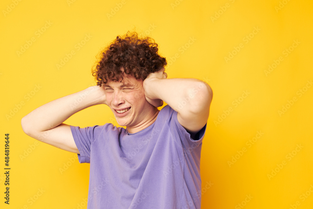 red-haired curly guy in a purple t-shirt gesture hands emotions red-haired curly guy in a purple t-shirt gesture hands emotions