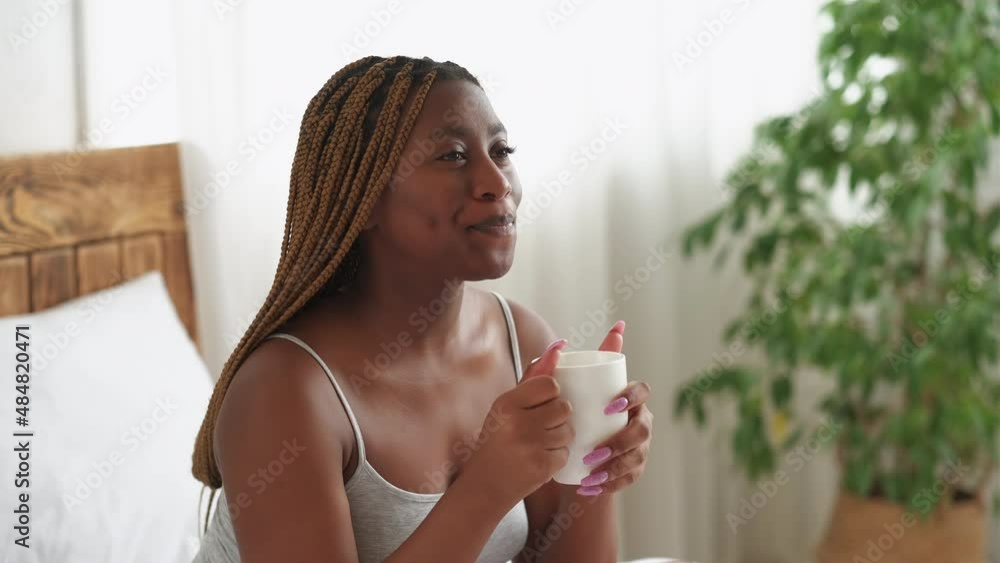 Morning energy. Coffee aroma. New day motivation. Positive start. Happy inspired smiling woman drinking tea enjoying hot beverage in mug in bed in light home bedroom interior. Morning energy. Coffee aroma. New day motivation. Positive start. Happy inspired smiling woman drinking tea enjoying hot beverage in mug in bed in light home bedroom interior.