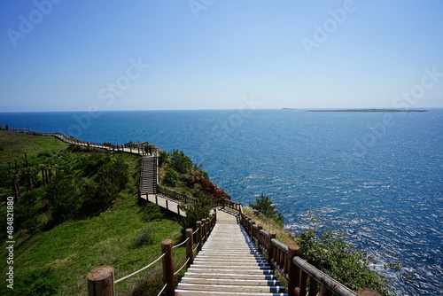 seaside cliff walkway and distant island