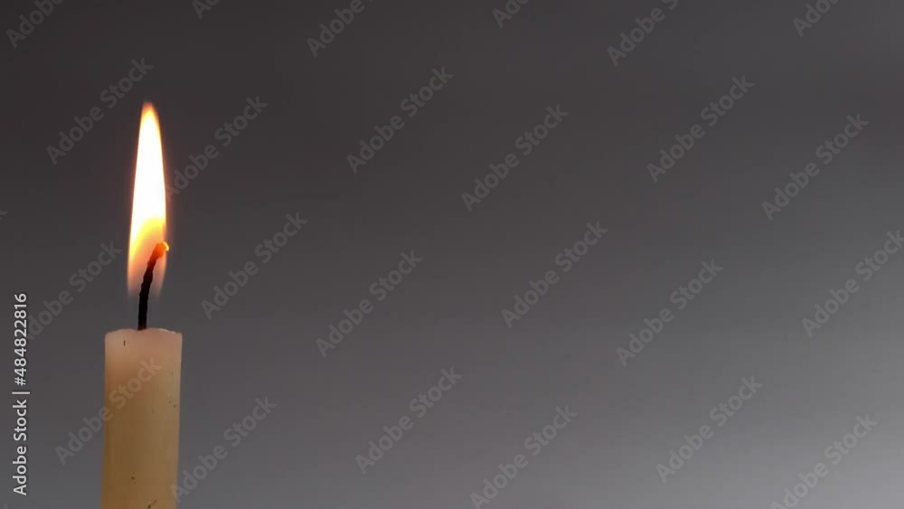 Candle burning time-lapse on grey background with copy space Candle burning time-lapse on grey background with copy space