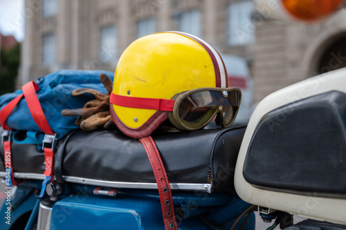 Vintage yellow helmet with glases on the motocyle photo