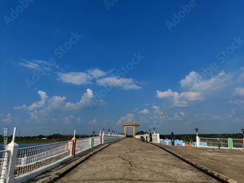 Photography Chitapur,India- October 6th 2021; Stock photo of bridge over bennithora dam, blue sky with white clouds on background