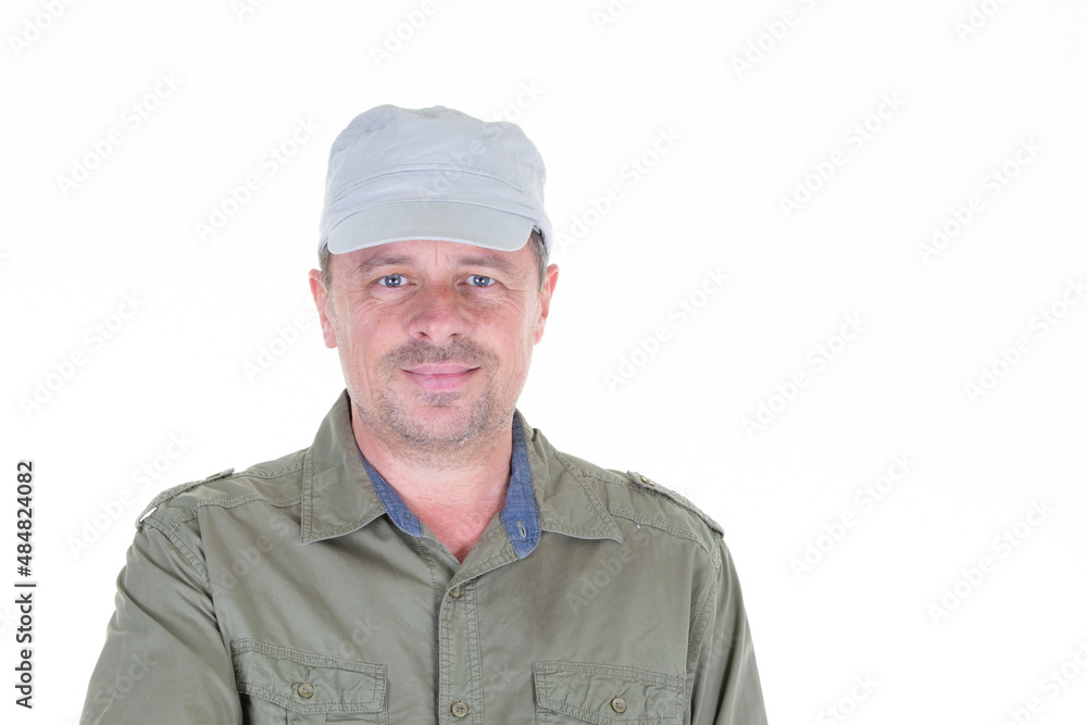 Middle-aged military cap man handsome posing in front of a white background with copy space