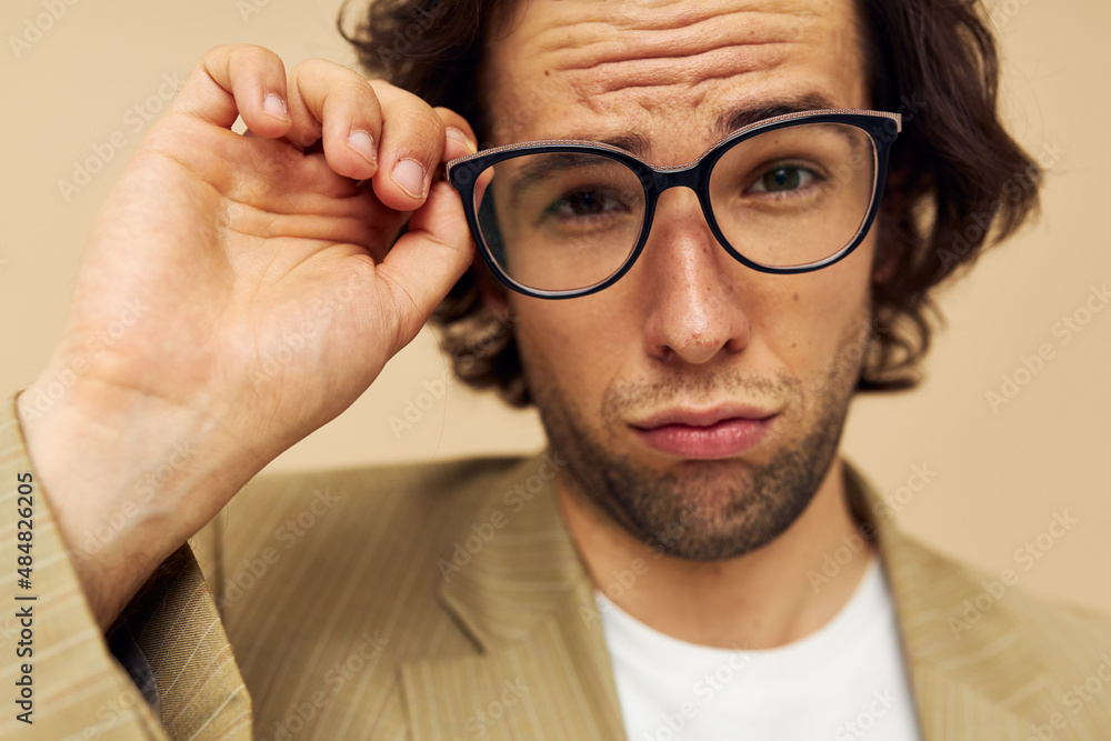 Cheerful man spectacled beige suit elegant style beige background Cheerful man spectacled beige suit elegant style beige background