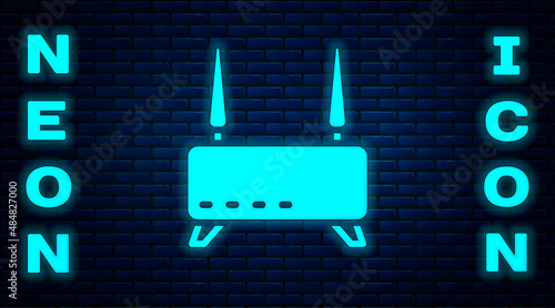 Glowing neon Router and wi-fi signal icon isolated on brick wall background. Wireless ethernet modem router. Computer technology internet. Vector