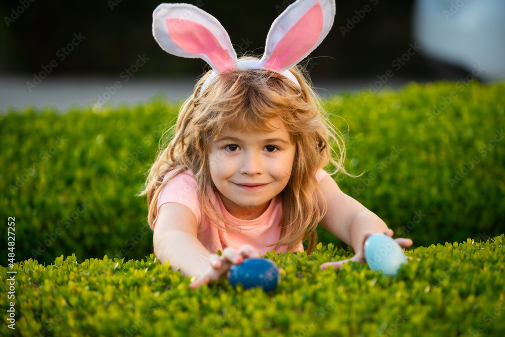 Kids boy hunting easter eggs. Easter bunny kids. Child boy in bunny Easter ears hunt eggs. Kids in bunny ears on Easter egg hunt in garden. Kids boy hunting easter eggs. Easter bunny kids. Child boy in bunny Easter ears hunt eggs. Kids in bunny ears on Easter egg hunt in garden.