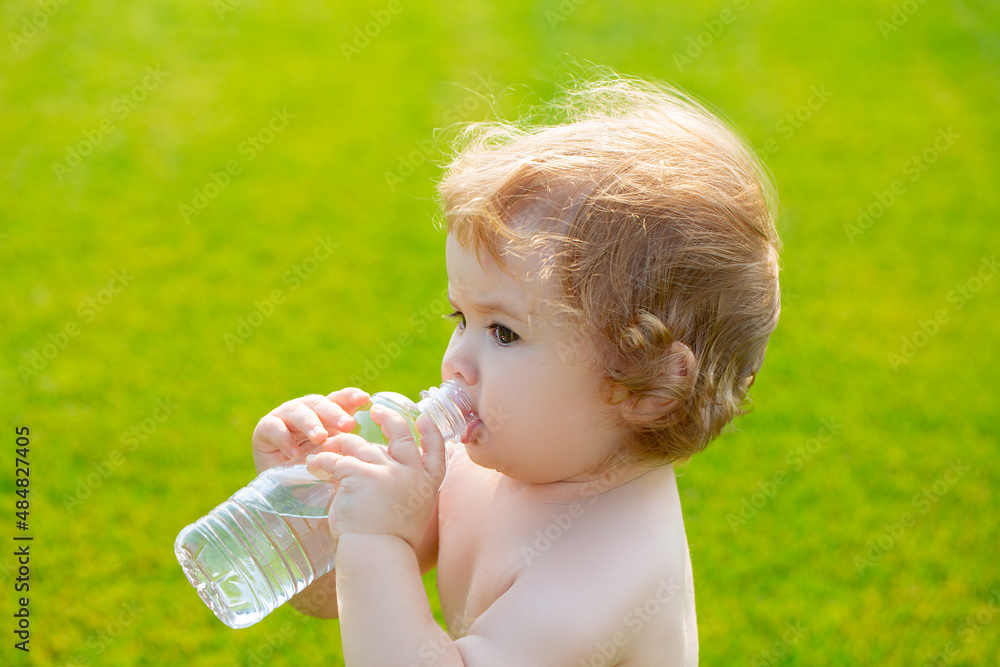 Kids baby drinking water. Adorable child baby drinking water from bottle outdoor. Kids baby drinking water. Adorable child baby drinking water from bottle outdoor.