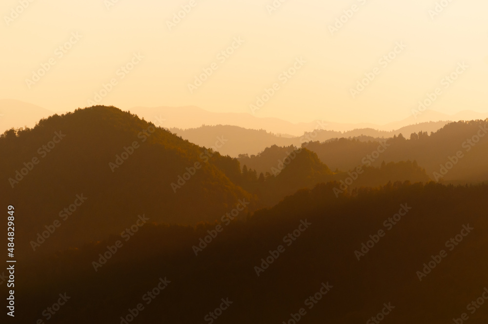 Beautiful landscape of numerous layers of orange hills at sunset time in Slovenia Beautiful landscape of numerous layers of orange hills at sunset time in Slovenia