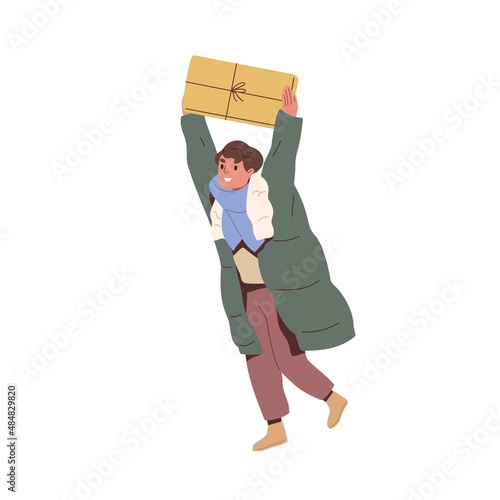 Happy child walking with gift outdoors. Kid holding Christmas present and rej...