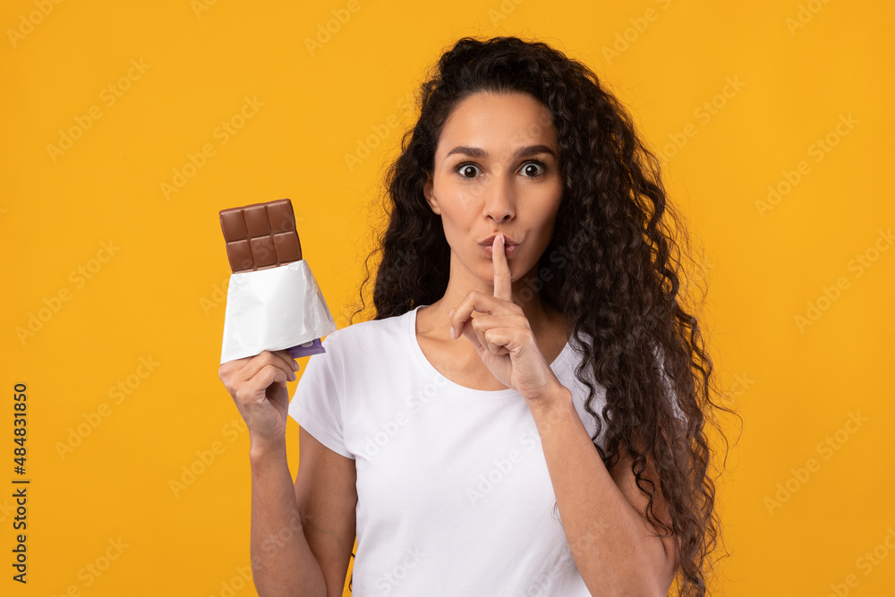 Hungry Latin Lady Holding Chocolate At Studio Hungry Latin Lady Holding Chocolate At Studio