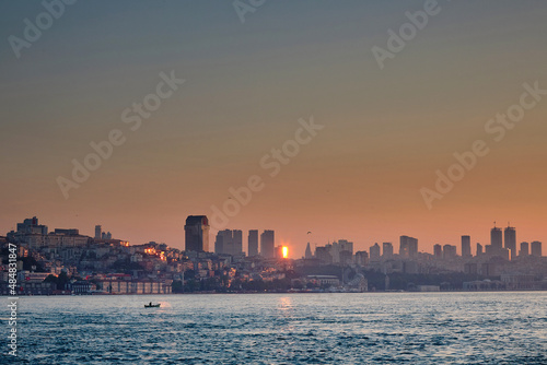 Houses on the sea coast at dawn. View of the city from the sea  boats  skyscrapers at sunrise. Journey to istanbul