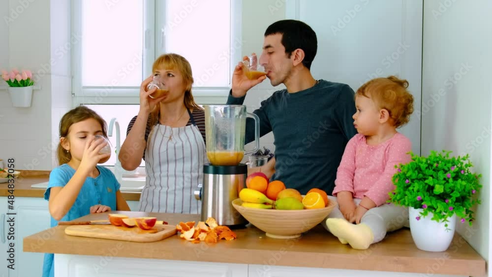 The family prepares smoothies at home. Selective focus.