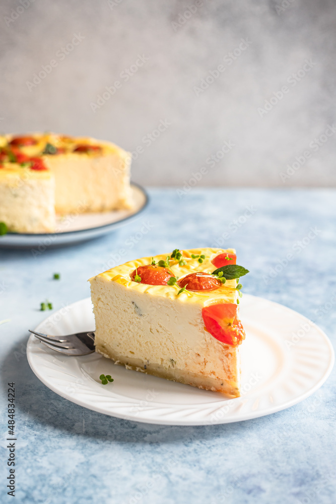 Piece of savoury tomato cheesecake with herbs decorated mint, blue background. Piece of savoury tomato cheesecake with herbs decorated mint, blue background.
