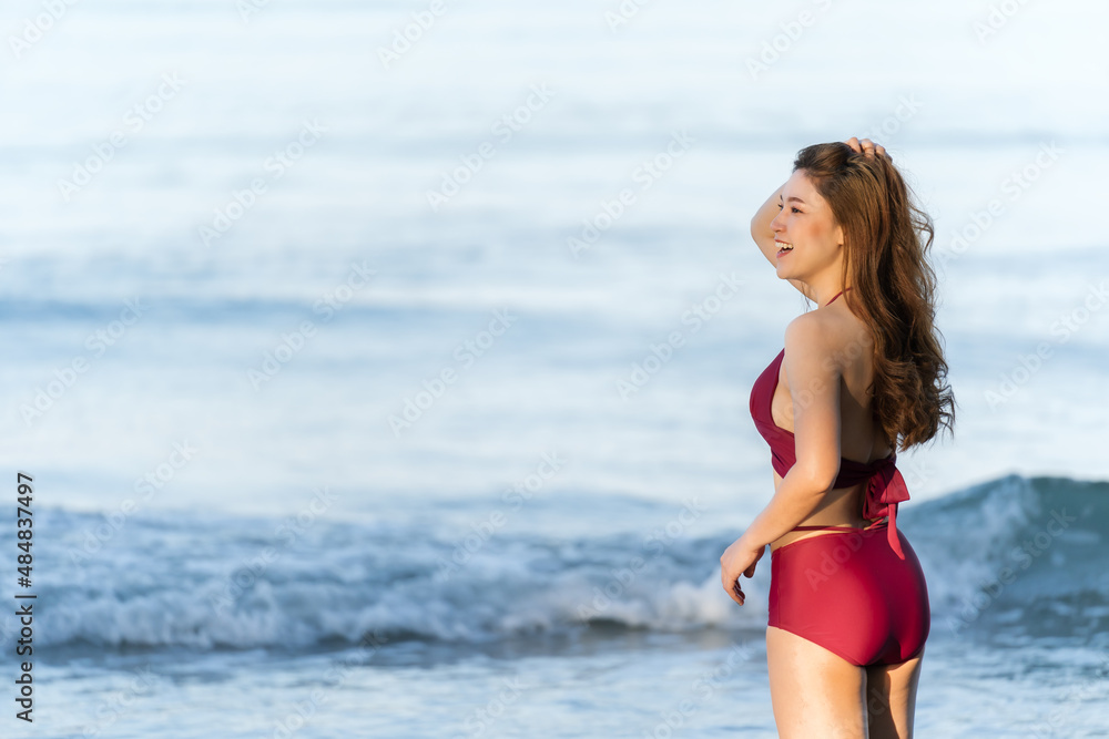happy woman in swimsuit on sea beach at Koh Chang island, Thailand