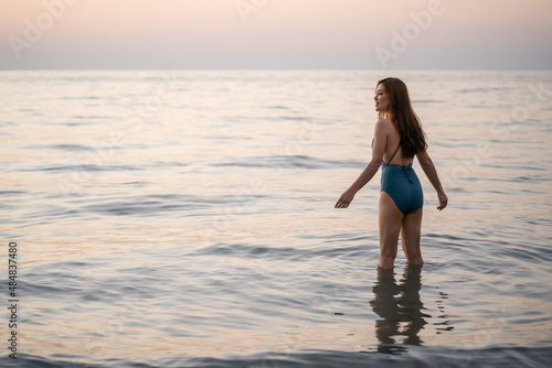 happy woman in swimsuit on sea beach at Koh Chang island, Thailand