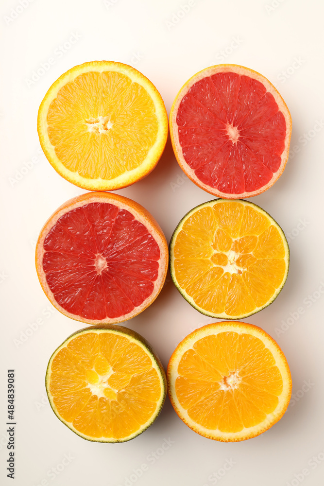Citrus fruits halves on white background, top view Citrus fruits halves on white background, top view