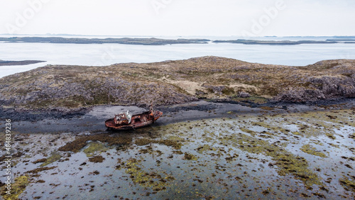 Shipwreck in Iceland. A fishing vessel is found stranded in low tide. Wooden boat left behind for several years now  © Rui
