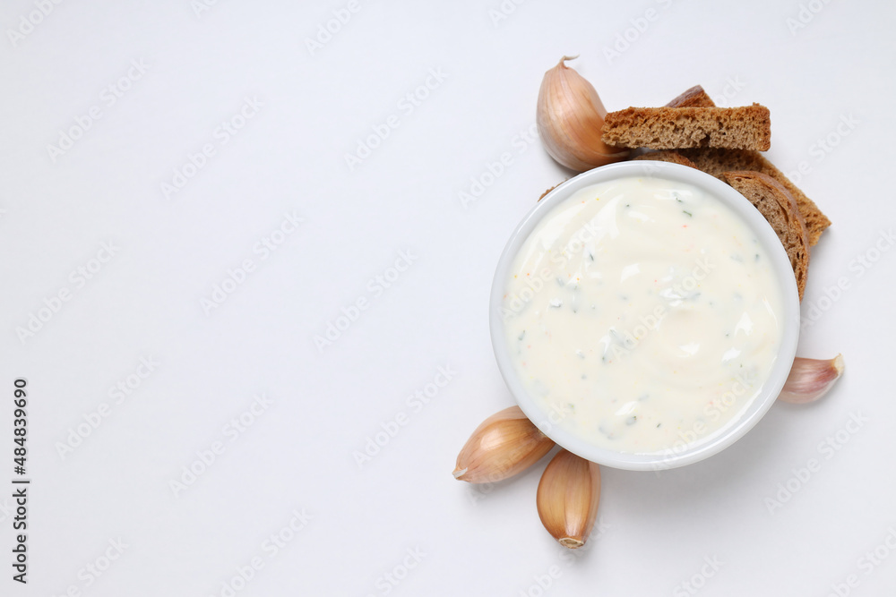 Garlic sauce, ingredients and snacks on white background Garlic sauce, ingredients and snacks on white background