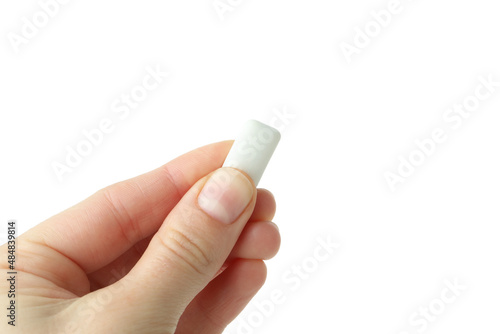 Female hand holds chewing gum, isolated on white background