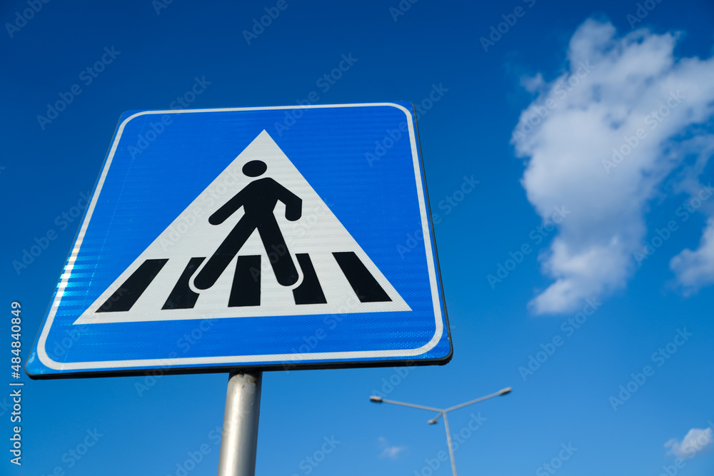 pedestrian crossing with blue background and a white cloud. pedestrian crossing with blue background and a white cloud.