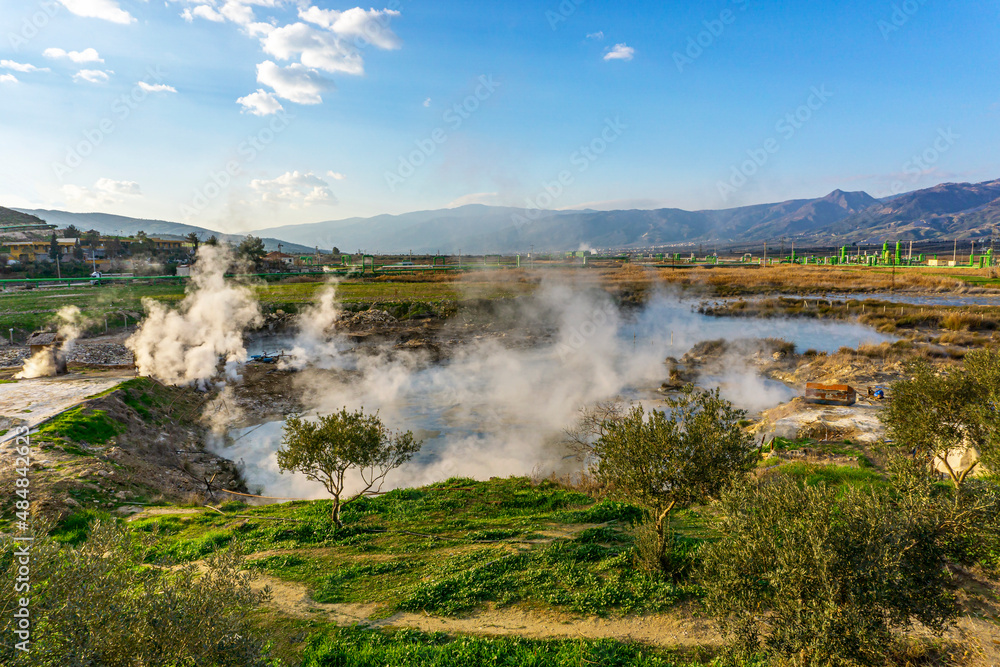 cenic views of thermal springs and mud bath in Sarayköy which contains bicarbonates and sulfates and power plant producing electricity from the geothermal steam, Denizli, Turkey