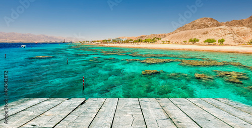Seascape with coral reefs and wooden flooring as a copy space, Red Sea, nature reserve in vicinity of Eilat, Middle East