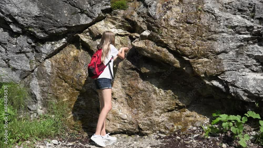 Young Girl Drinking Water from Mountains River Waterfall, Kid Playing in Spring, Tourist Child Hiking at Camping, Trip, Excursion Young Girl Drinking Water from Mountains River Waterfall, Kid Playing in Spring, Tourist Child Hiking at Camping, Trip, Excursion