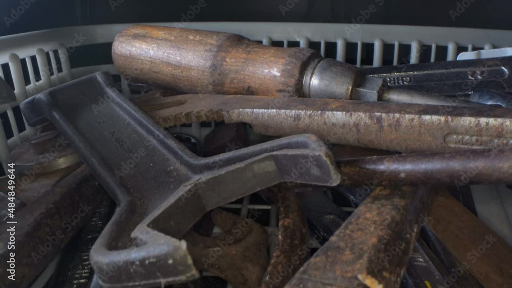 Old rusty and worn tools lying jumbled in a box, 4k macro Old rusty and worn tools lying jumbled in a box, 4k macro