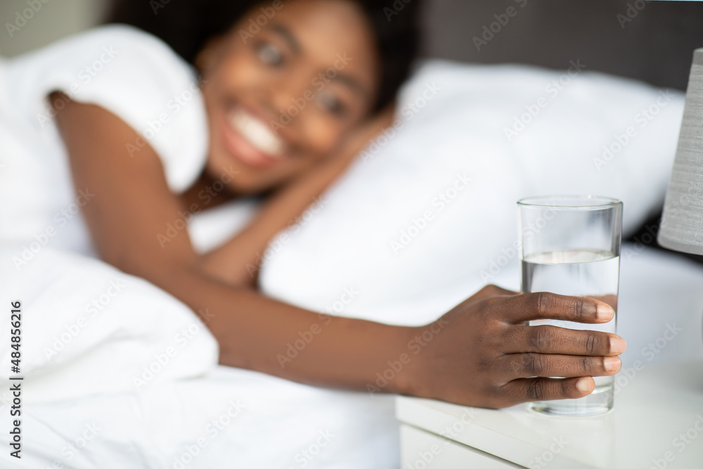 Selective focus on glass of water at bedside Selective focus on glass of water at bedside