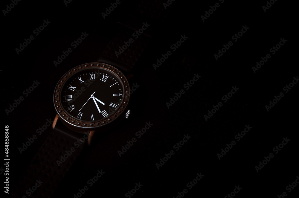 Men's accessory. Men's watches on a dark background with Roman numerals. Stock photo