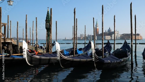 Venice, Italy - January 30, 2022 - Boats on the Grand Canal in the background the church of San Giorgio at dusk