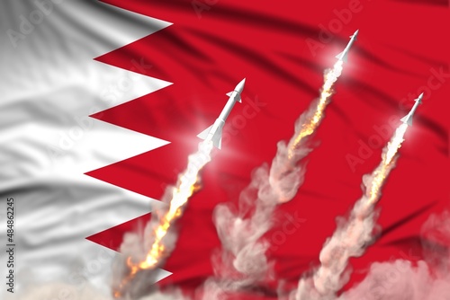 Bahrain ballistic missile launch - modern strategic nuclear rocket weapons concept on flag fabric background, military industrial 3D illustration with flag photo