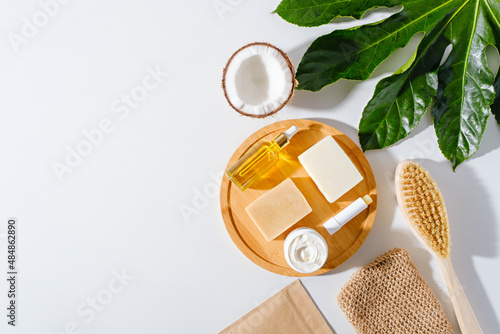 eco body care, natural soap, dry massage brush, cream, washcloth on white background, organic cosmetic products concept photo