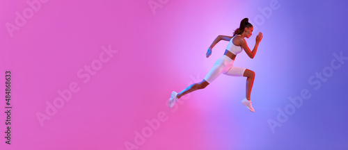 Sporty Female Running In Mid-Air Exercising Over Neon Background  Panorama