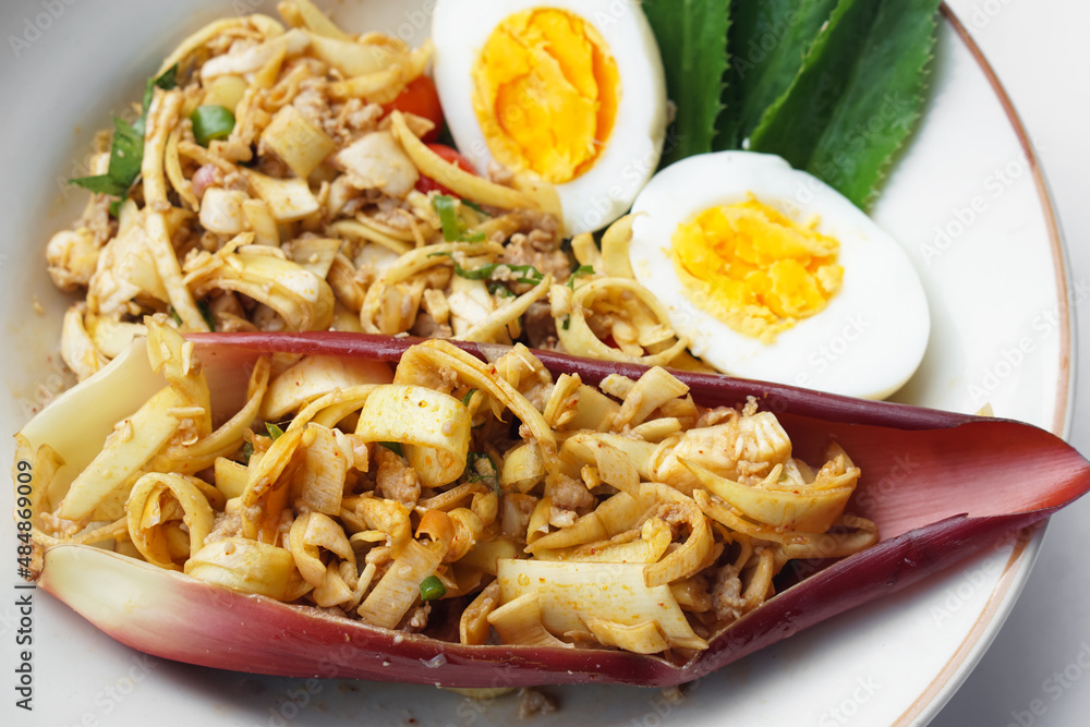 Banana flower spicy salad with boiled eggs and vegetable, Thai traditional food on dish. Banana flower spicy salad with boiled eggs and vegetable, Thai traditional food on dish.