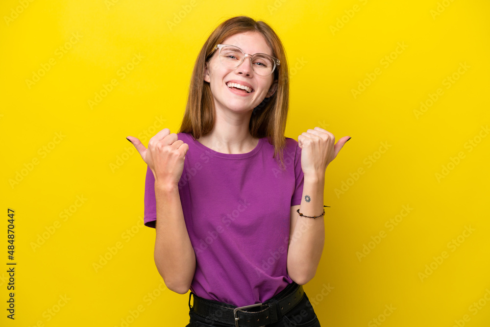 Young English woman isolated on yellow background with thumbs up gesture and smiling Young English woman isolated on yellow background with thumbs up gesture and smiling