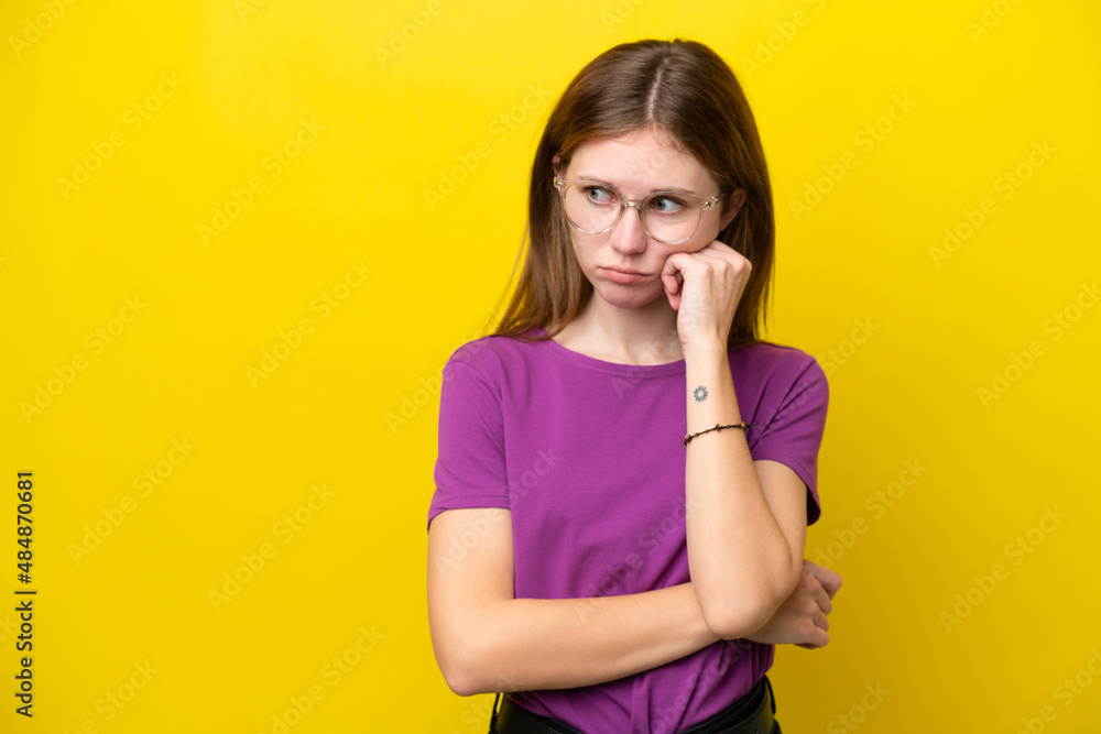 Young English woman isolated on yellow background with tired and bored expression Young English woman isolated on yellow background with tired and bored expression