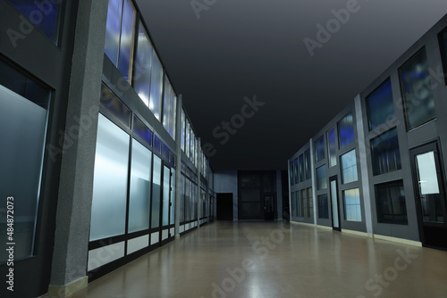 Modern empty office corridor with glass walls