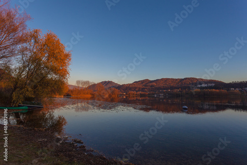 Prosecco Unesco Hills that are reflected on the waters of a lake during an autumn sunset. Revine Lakes, Veneto, Italy. Concept about reflection and relaxation. Popular travel destination